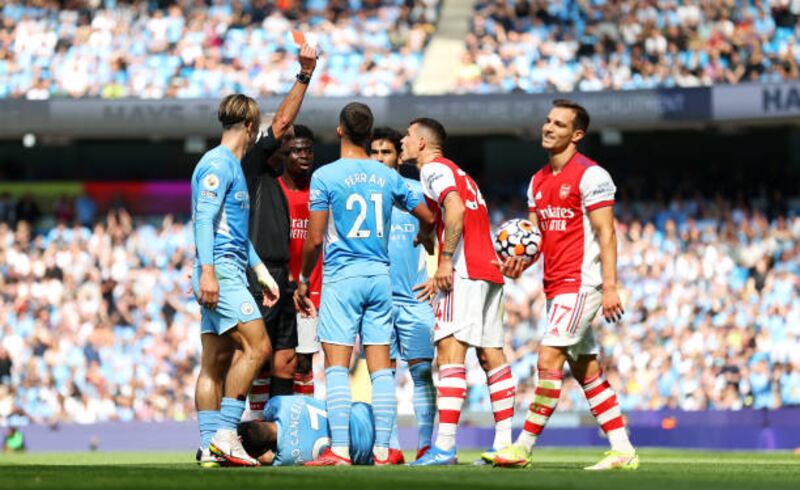 Referee Martin Atkinson shows Granit Xhaka a red card. Getty