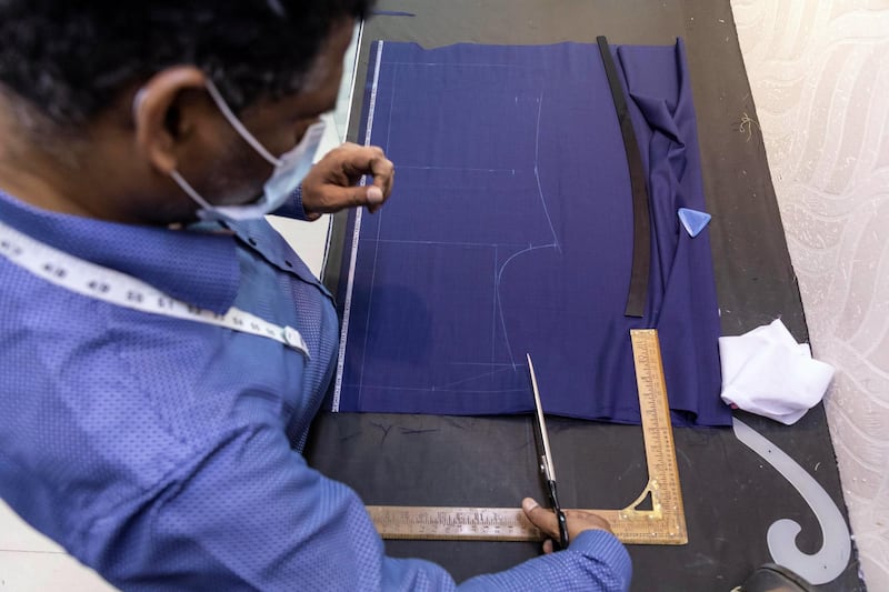 Eid Tailors. Tailors in Dubai are on the road to recovery as Eid outfit orders pick up this year compared to last year. Staff at Kachins in Bur Dubai do last minute work to get this years Eid outfit orders ready before the end of Ramadan tonight on May 10th, 2021. 
Antonie Robertson / The National.
Reporter: Kelly Clarke for National.