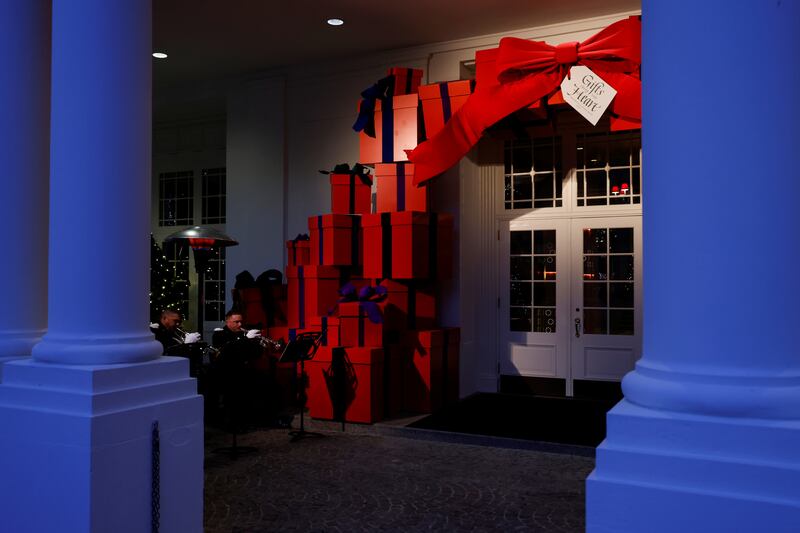 Members of the US  Marine Corps Band play holiday music at the entrance to the East Wing at the White House in Washington. Reuters