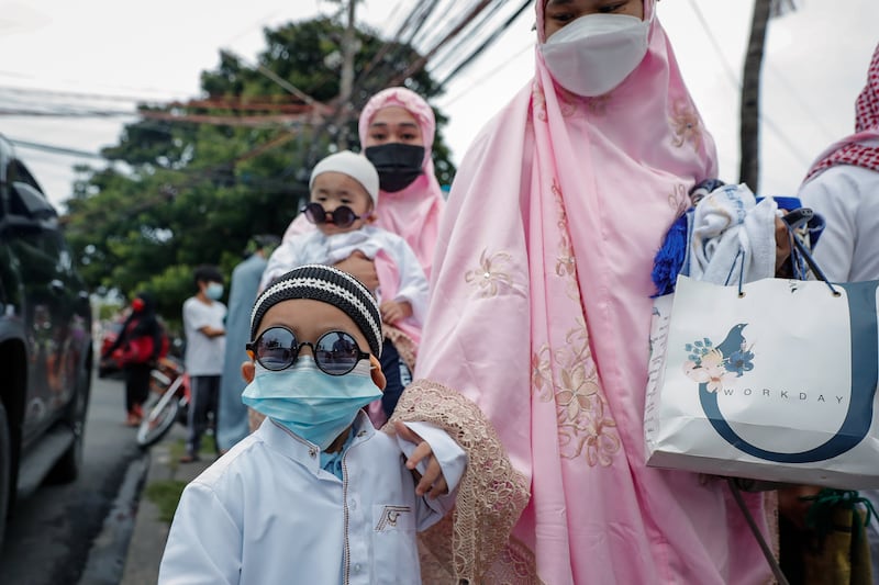 A child arrives with his family to mark Eid Al Adha at the Blue Mosque in Taguig city, south of Manila, in the Philippines.