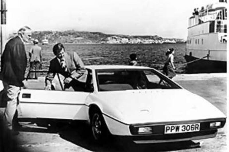 Roger Moore climbs into the white 1976 Lotus Esprit which fetched Dh609,350 at a London sale.