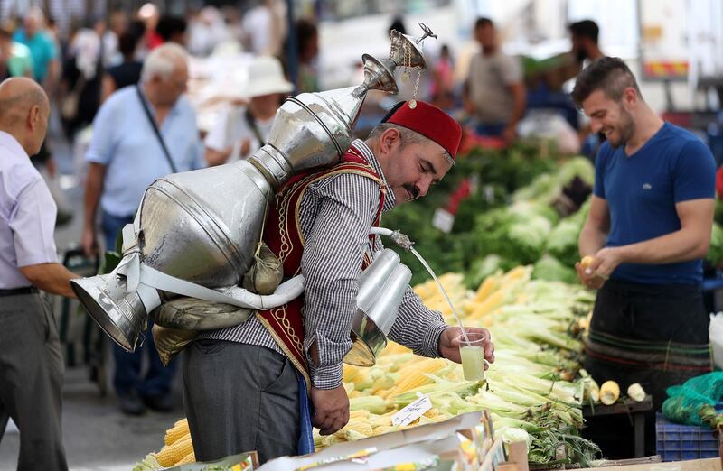 epa06983628 A man sells lemonade with an ottoman costume at a local bazaar in Istanbul, Turkey, 30 August 2018. Turkey's economic confidence has dropped to its lowest level because of the pressure on the country's trembling currency. The lira lost 38 percent of its value in August 2018.  EPA/ERDEM SAHIN