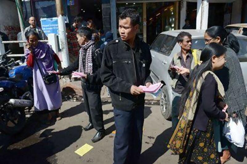 A member of Syngkhong Rympei Thymmai, a men's rights organisation, distributes leaflets promoting the organisation in Shillong. Roberto Schmidt / AFP