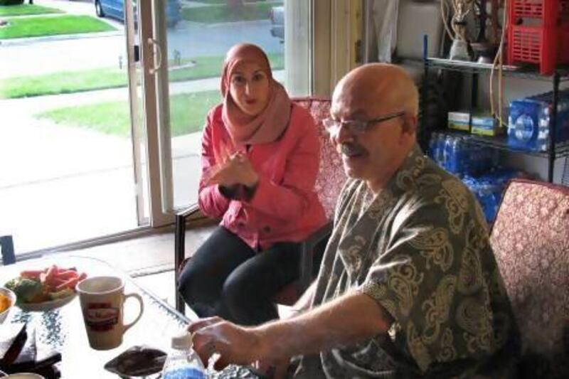Mariam Khalaf, left, and her neighbour, Muheeb Nabulsy in Orchard Street, Dearborn.  Both have added sliding doors to their garages and use them like patios.