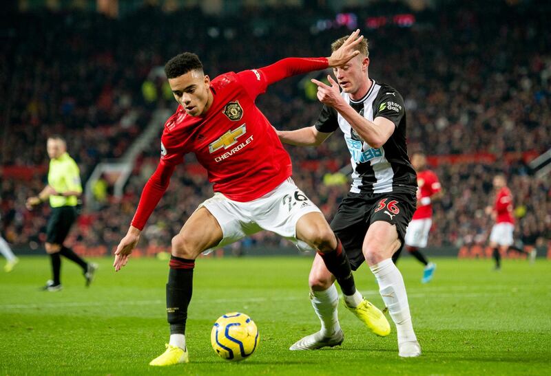 Manchester United's Mason Greenwood vies for the ball with Newcastle's Sean Longstaff at Old Trafford. EPA
