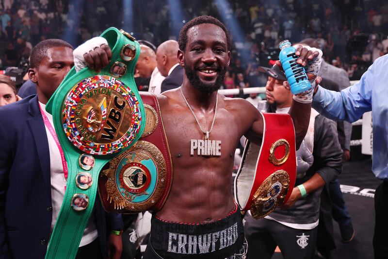 Terrence Crawford celebrates with his championship belts after defeating Errol Spence Jr. Getty Images