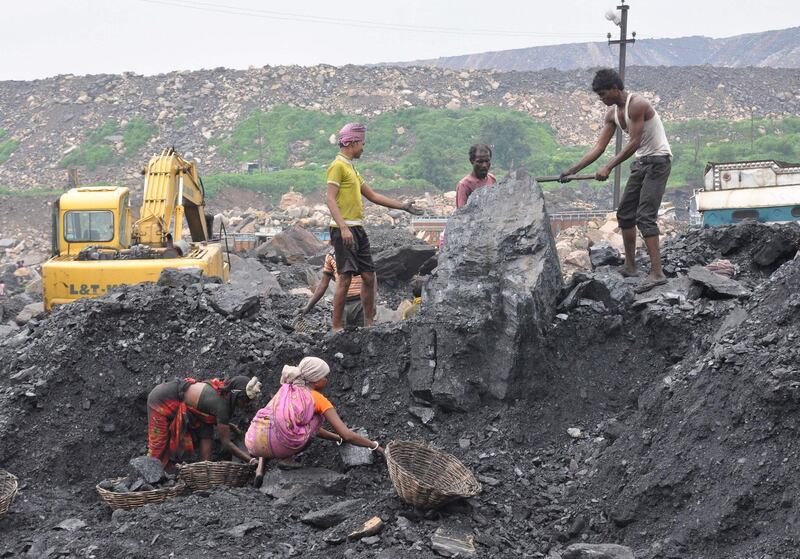 This photo taken on December 7, 2017 shows Indian labourers collecting coal at an open mine in Dhanbad in the eastern Indian state of Jharkhand.
Hundreds of millions of people in India are forced to live with the fallout of the dirtiest fuels -- with the government blaming a lack of funds to pay for greener power. Money will be the key issue when about 100 countries meet in Paris on December 12 for the One Planet Summit organised by French President Emmanuel Macron. The meeting will focus on marshalling public and private funds to speed the move to a low-carbon economy. Developing countries say barely a tenth of the $100 billion promised by the end of the decade under a 2010 deal has come in so far. / AFP PHOTO / -
