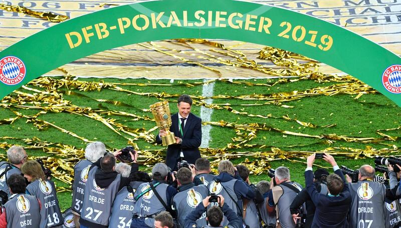 Bayern Munich's Croatian head coach Niko Kovac celebrates with the German Cup after Bayern beat RB Leipzig at the Olympic Stadium in Berlin. AFP