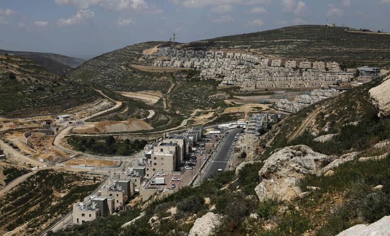 A picture taken on April 19, 2019 shows construction works underway in the Israeli settlement of Givat Zeev near the occupied West Bank city of Ramallah. / AFP / AHMAD GHARABLI
