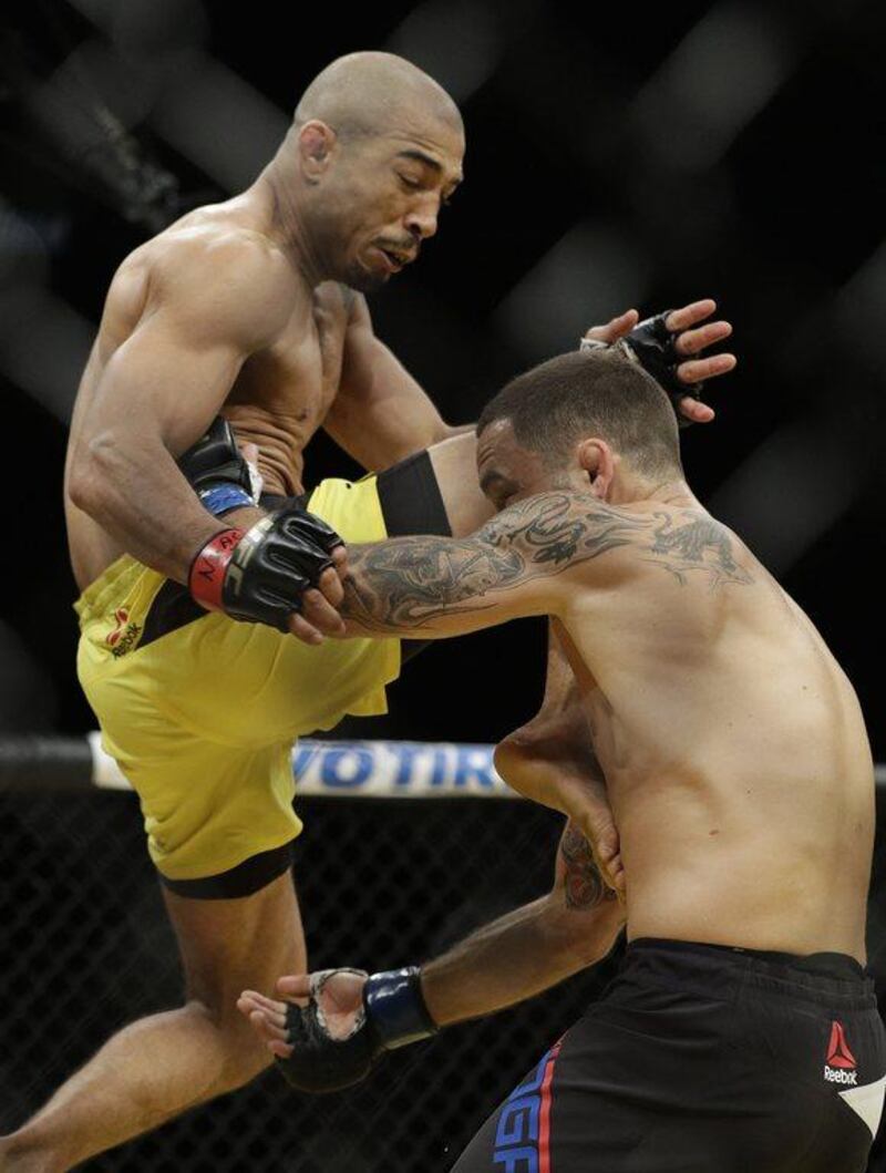 Jose Aldo, left, lands a knee to Frankie Edgar during their featherweight championship bout at UFC 200, Saturday, July 9, 2016, in Las Vegas. John Locher / AP Photo