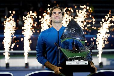 Roger Federer poses with the 100th trophy of his career after defeating Stefanos Tsitsipas in the Dubai Duty Free Tennis Championships final on Saturday. EPA