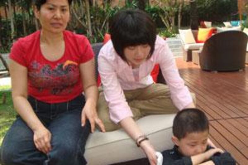Geng He, left, the wife of Gao Zhisheng, their daughter Geng Ge, centre, and their son Gao Tianyu.