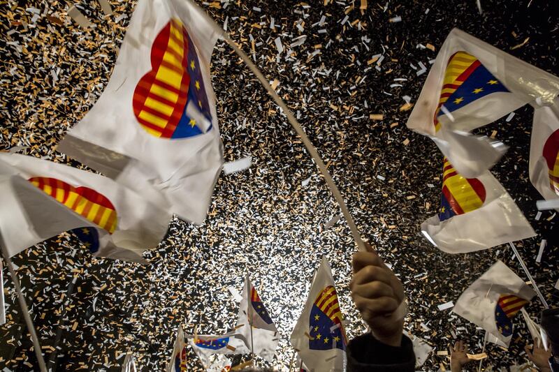 Confetti flies as supporters wave flags at the Ciudadanos party headquarters. Angel Garcia / Bloomberg