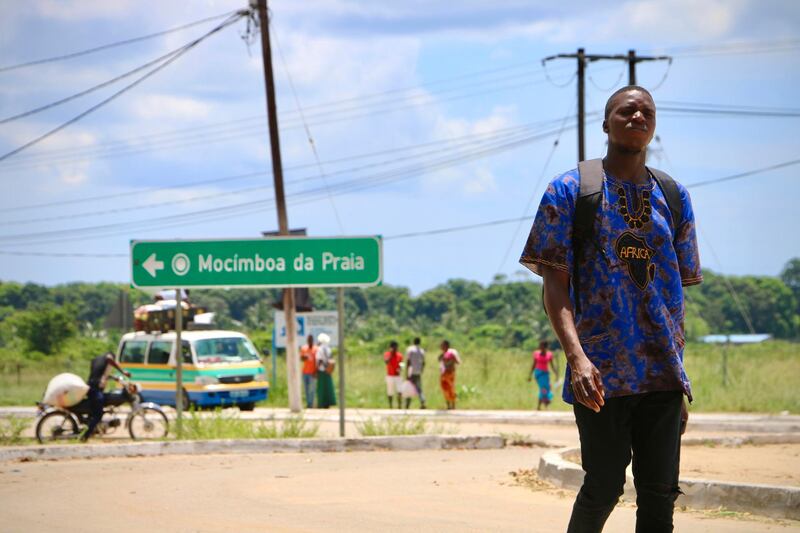 A man walks by the main entrance to the city on March 8, 2018 in Mocimboa da Praia, Mozambique. - Security is increased in the area following a two days attack from suspected islamists in October last year where they took control of the city. (Photo by ADRIEN BARBIER / AFP)