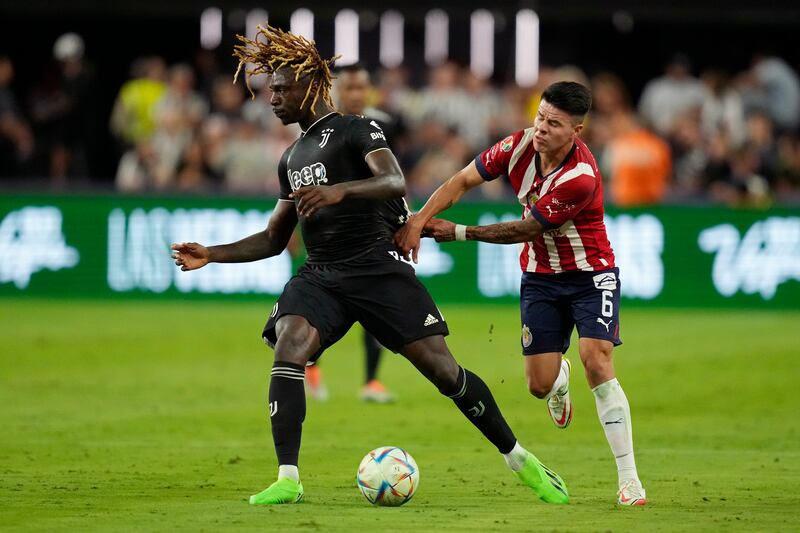 Chivas' Pavel Perez, right, pulls on the jersey of Juventus' Moise Kean during their friendly. AP
