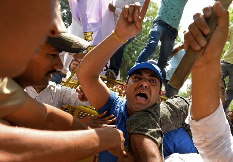 Indian supporters of the Delhi Pradesh Youth Congress shout slogans against Delhi Chief Minister Arvind Kejriwal as they clash with police outside his house during a protest against the suicide of a farmer at a rally organised by Kejriwal's Aam Admi Party in New Delhi on April 23. AFP Photo