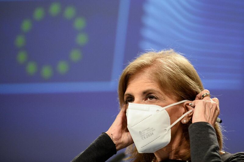 European Commissioner in charge of Health Stella Kyriakides removes her face mask during an online news conference at the EU headquarters in Brussels, Friday, Jan. 29, 2021. The European Union and AstraZeneca agreed Friday to make public a heavily redacted version of their coronavirus vaccine agreement, which lies at the heart of a dispute over how many shots the pharmaceutical company should be supplying the EU's 27 nations. (Johanna Geron, Pool Photo via AP)