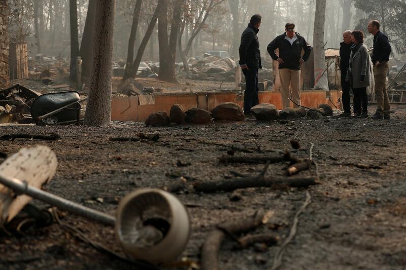 U.S. President Donald Trump visits the charred wreckage of Skyway Villa Mobile Home and RV Park with Governor-elect Gavin Newsom (L), Brock Long (R), Paradise Mayor Jody Jones (2nd R) and Governor Jerry Brown in Paradise, California, U.S., November 17, 2018. REUTERS/Leah Millis     TPX IMAGES OF THE DAY