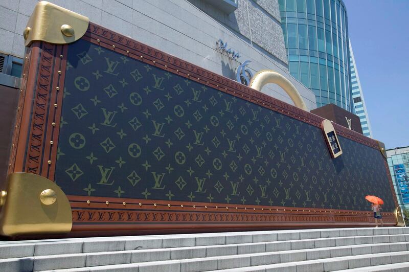 epa08569005 (FILE) - A file picture dated 09 August 2004 shows a giant mockup of a suitcase outside an official retail outlet of the French luxury goods maker Louis Vuitton in Shanghai, China (reissued 27 July 2020). LVMH Moet Hennessy Louis Vuitton SA, the world's leading luxury group, on 27 July 2020 released their first half year ended 30 June 2020 results, saying their revenue stood at 18,393 million euro, less 27 per cent from 25,082 million euro in 2019. Net profit in the same period was 544 million euro, down from 3,603 million euro in 2019.  EPA/YONHAP SOUTH KOREA OUT *** Local Caption *** 55585383