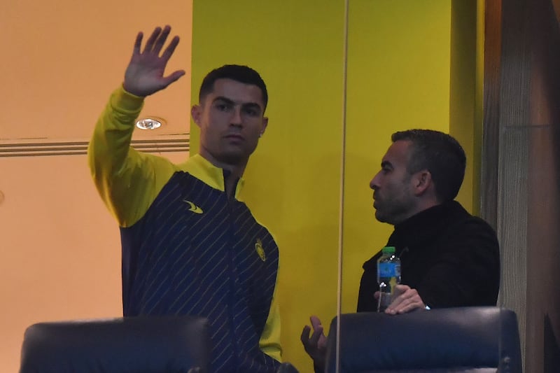Al Nassr's Portuguese forward Cristiano Ronaldo watches from the stand as his team take on At Ta'ee at the Mrsool Park Stadium in Riyadh on Friday, January 6, 2023. AFP