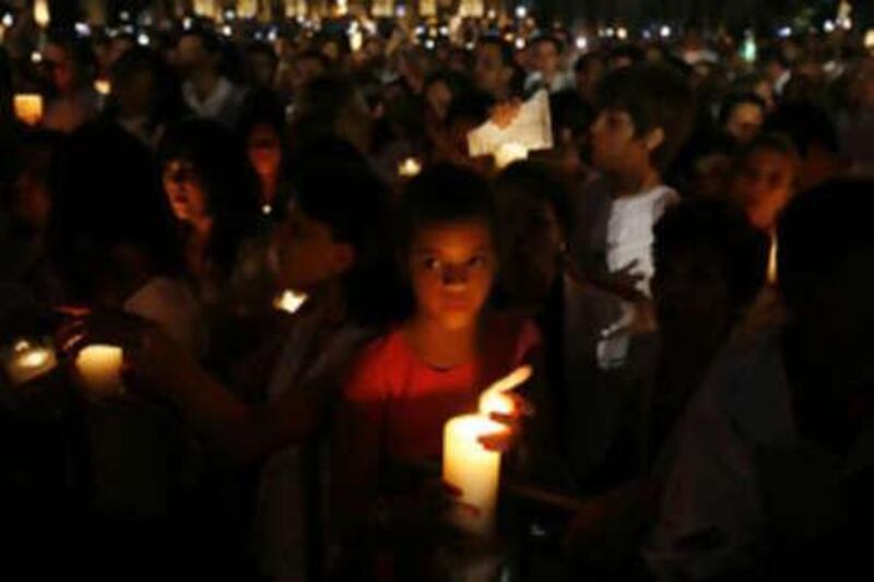 People hold candles at the Macroplaza in downtown Monterrey on Aug 30. Thousands of Mexicans dressed in white marched on Saturday to protest a wave of kidnappings and gruesome murders, putting pressure on the president Felipe Calderón, to meet his promises to crack down on crime.