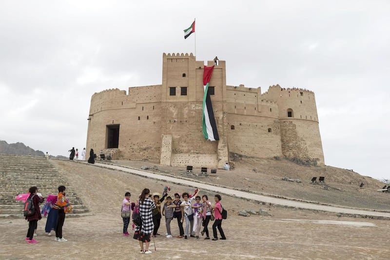 Chinese tourists at Fujairah Fort. Many such historic monuments make the emirate a popular tourist destination. Antonie Robertson / The National