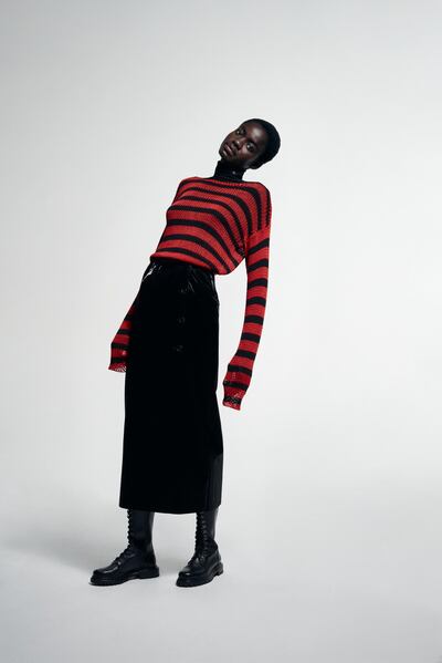 A striped sweater from the spring / summer 1997 collection for men is photographed on a female model, as part of the Raf Simons Archive Redux at Matches Fashion