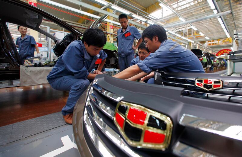 Employees check plastic bumpers along a Geely Automobile Corporation assembly line in Cixi, Zhejiang province June 21, 2012. Car sales in China rose 22.6 percent in May from a year earlier, the China Association of Automobile Manufacturers (CAAM) said on June 9. REUTERS/Carlos Barria  (CHINA - Tags: BUSINESS TRANSPORT) - RTR33Y4J