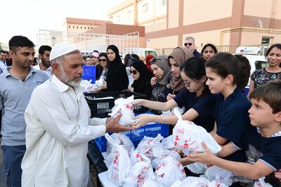 Students from the Mohammed Bin Rashid University hand out iftar meals. Courtesy Mohammed Bin Rashid University