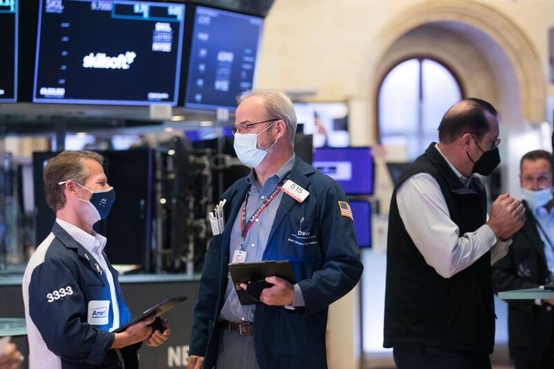 In this photo provided by the New York Stock Exchange, traders work on the floor, Thursday, June 17, 2021. Stock indexes are flipping between small gains and losses on Wall Street Thursday, as investors make preparations for a future where the Federal Reserve is no longer doing everything it can to support the economy. (Courtney Crow/New York Stock Exchange via AP)