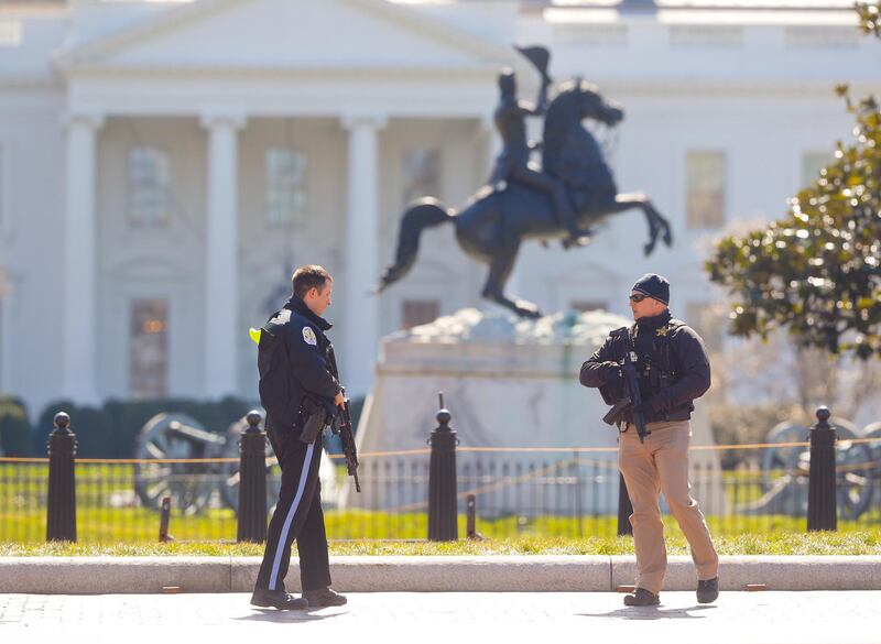 Law enforcement officers at Lafayette Park across from the White House in Washington, close the area to pedestrian traffic, Saturday, March 3, 2018. A man apparently shot himself along the north fence of the White House midday, according to the Secret Service, which also said he was being treated for the wound. (AP Photo/Pablo Martinez Monsivais)