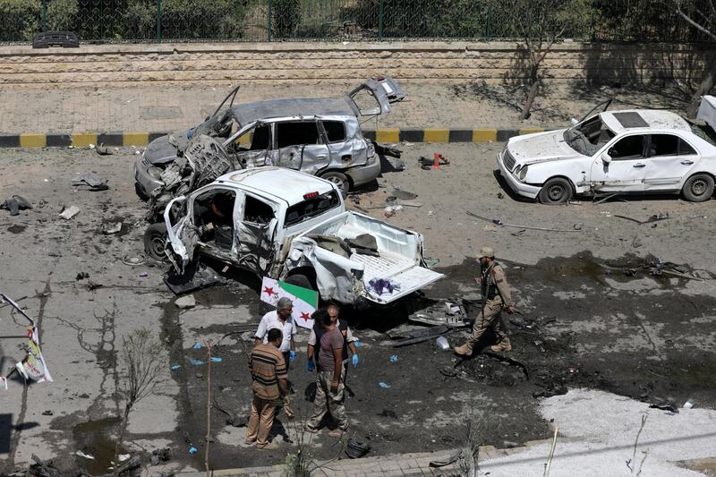 Free Syrian Army members (FSA) inspect damaged cars after a car bomb in Azaz, Syria. Reuters