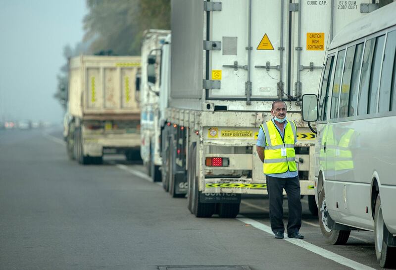 Abu Dhabi, United Arab Emirates, March 4, 2021.  A truck driver pulls to the side of the road on a foggy morning at Abu Dhabi along the E10 highway. 
Victor Besa / The National
Section:  NA