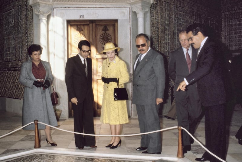 British Royal Queen Elizabeth II, wearing a yellow outfit with a yellow hat and black evening gloves, and Prince Philip, Duke of Edinburgh, visit the Carthage Room of the Bardo National Museum in Tunis, during her three-day State Visit to Tunisia, 22nd October 1980. (Photo by Tim Graham Photo Library via Getty Images)