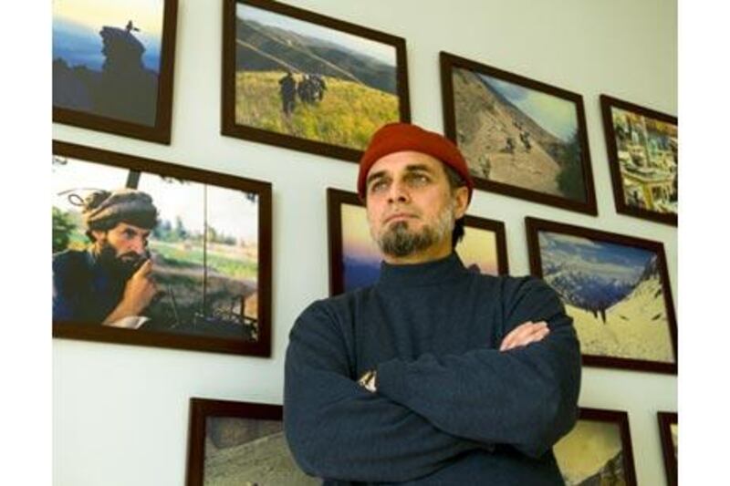 Zaid Hamid, pictured in Rawalpindi, standing in front of photographs of his own mujahideen past.