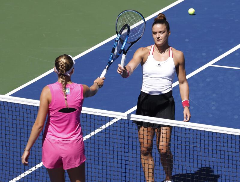 Maria Sakkari and Amanda Anisimova tap racquets at the net after their US Open third round match. EPA