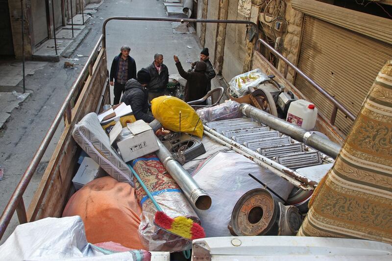 Syrians load their belongings into a truck before driving away from Maaret Al-Numan in the northwestern Idlib province.  AFP