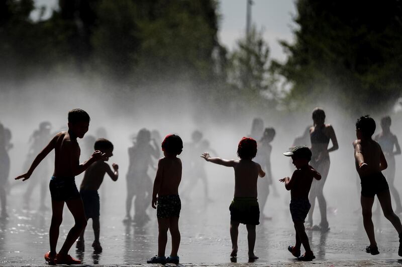 Children play in a fountain during a hot summer day, in Madrid, Spain. EPA