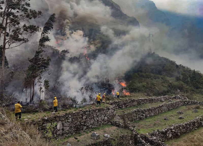 Firefighters work to put out a blaze near the ruins of Machu Picchu. AFP