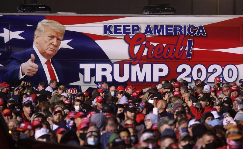 A bus with an image of US President Donald Trump sits next to the crowd during a campaign rally at Richard B. Russell Airport in Rome, Georgia. AFP