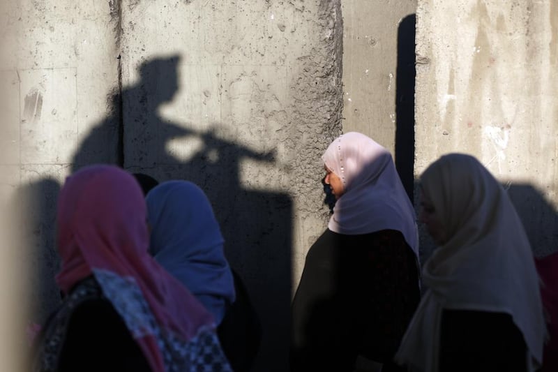 Palestinians wait to cross the Qalandia checkpoint between Ramallah and Jerusalem on their way to Al Aqsa Mosque. Abbas Momani / AFP