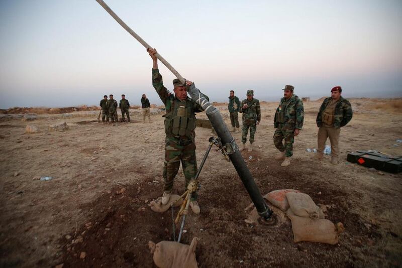 Peshmerga forces prepare to launch a mortar during an operation to attack Islamic State militants in the town of Naweran near Mosul. Azad Lashkari / Reuters