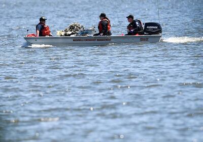 Emergency personnel remove debris from a plane crash in Percy Priest Lake Sunday, May 30, 2021, near Smyrna, Tenn. A small jet carrying seven people crashed Saturday, and authorities indicated that no one on board survived. (George Walker IV/The Tennessean via AP)
