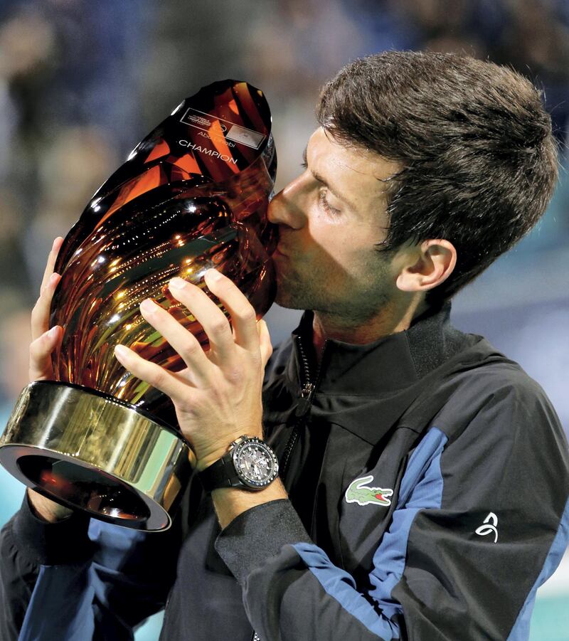 epa07253256 Novak Djokovic of Serbia kisses the trophy after winning the final match against Kevin Anderson of South Africa at the Mubadala World Tennis Championship 2018 in Abu Dhabi, United Arab Emirates, 29 December 2018.  EPA/ALI HAIDER