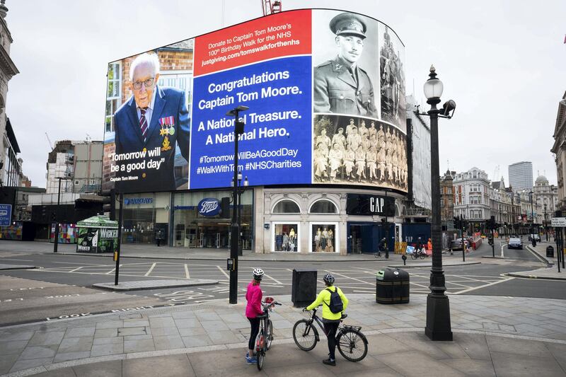 An hourly salute to Captain Tom the army veteran in Piccadilly Circus, London. 99-year-old war veteran Captain Tom Moore's challenge to raise money for NHS charities to walk 100 laps of his garden before his 100th birthday has hit Â£20 million, less than two weeks after he began the challenge. He completed his 100 laps on Thursday. (Photo by Aaron Chown/PA Images via Getty Images)