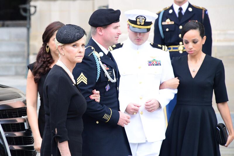 Cindy McCain (L) the widow of US Senator John McCain and her sons arrive at the Washington National Cathedral for her husband's memorial service. AFP