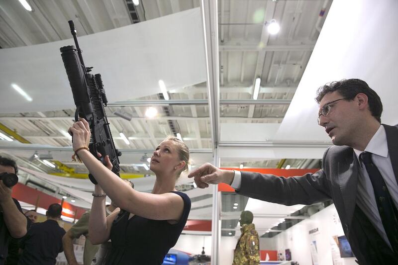 A visitor checks out an ARX 160 assault rifle on display aboard the Italian aircraft carrier Cavour. Silvia Razgova / The National
