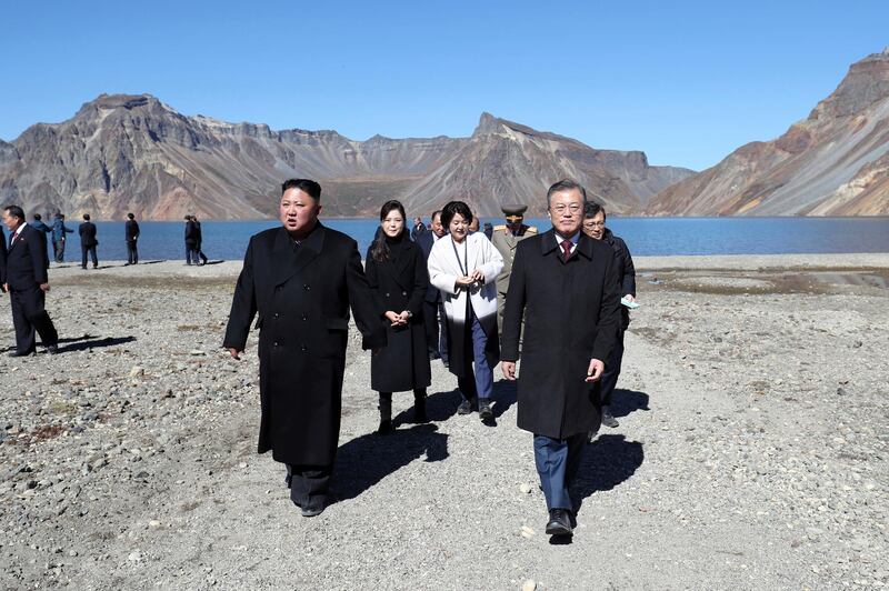 North Korean leader Kim Jong Un, left, and South Korean President Moon Jae-in visit Mount Paektu, in North Korea, Thursday, Sept. 20, 2018. A beaming South Korean President Moon, freshly returned home Thursday from a whirlwind three-day summit with Kim Jong Un, said the North Korean leader wants the U.S. secretary of state to visit Pyongyang soon for nuclear talks, and also hopes for a quick follow-up to his June summit with President Donald Trump. (Pyongyang Press Corps Pool via AP)