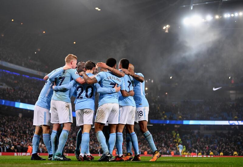 MANCHESTER, ENGLAND - DECEMBER 16:  Raheem Sterling of Manchester City celebrates after scoring his sides fourth goal with his Manchester City team mates during the Premier League match between Manchester City and Tottenham Hotspur at Etihad Stadium on December 16, 2017 in Manchester, England.  (Photo by Laurence Griffiths/Getty Images)