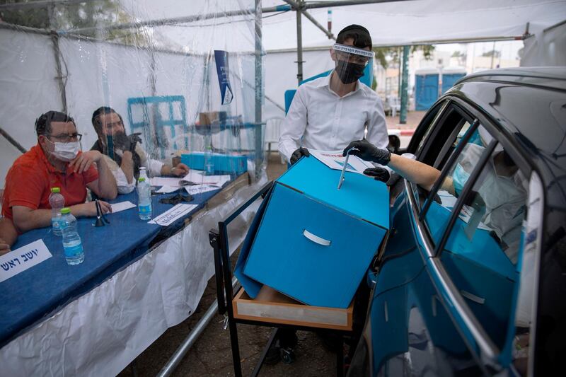 A women votes for Israel's parliamentary election at a special drive-in polling station for people who are in quarantine for coronavirus, in Ramat Gan. AP Photo